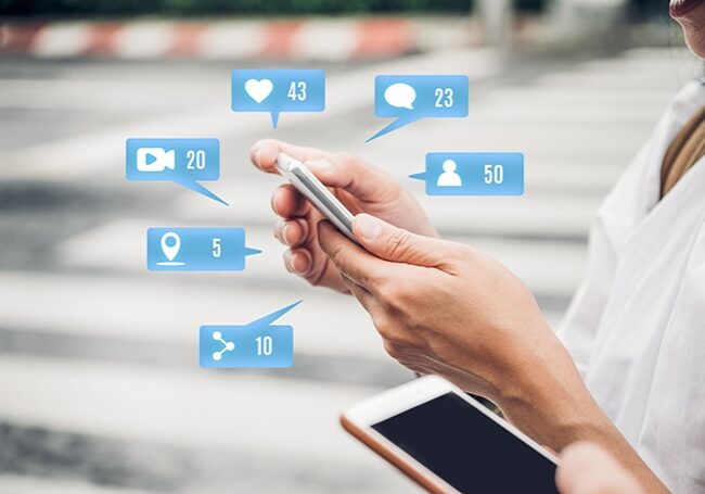 Close up woman hand using social media app on mobile phone to respond to online reviews.