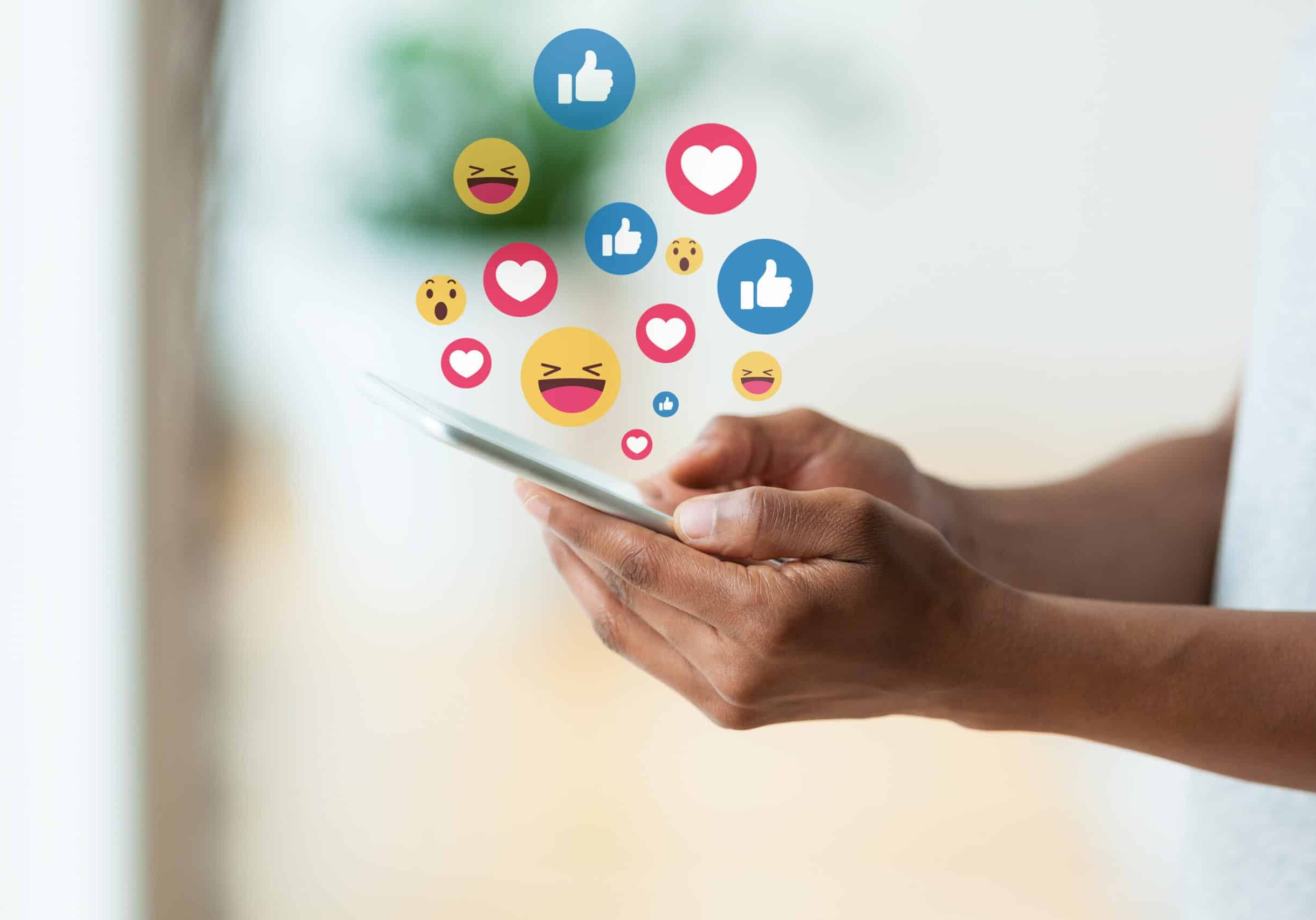 person holding a tactile mobile smartphone sending text messages emoji