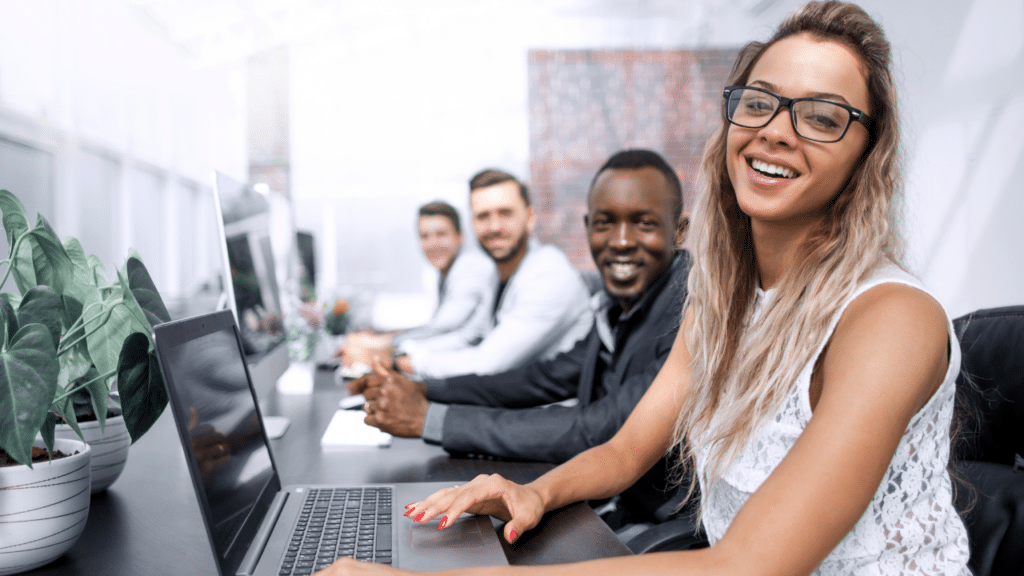 Apartment office staff smiling at their desks.